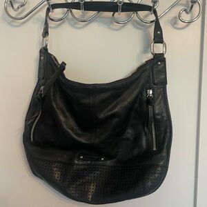 B Makowsky black leather purse with tassels & silver detail. 3 inside pockets.